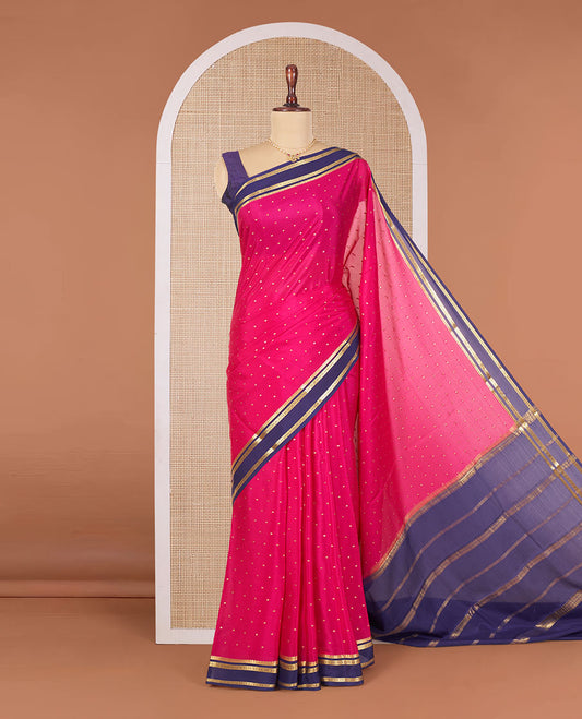 Pink Mysore Silk Saree Detailed with Zari Buttas, Complemented by a Contrast Border Featuring Traditional Zari Designs, Pallu Steeped with Zari Stripes, and Paired with a Contrast Blouse
