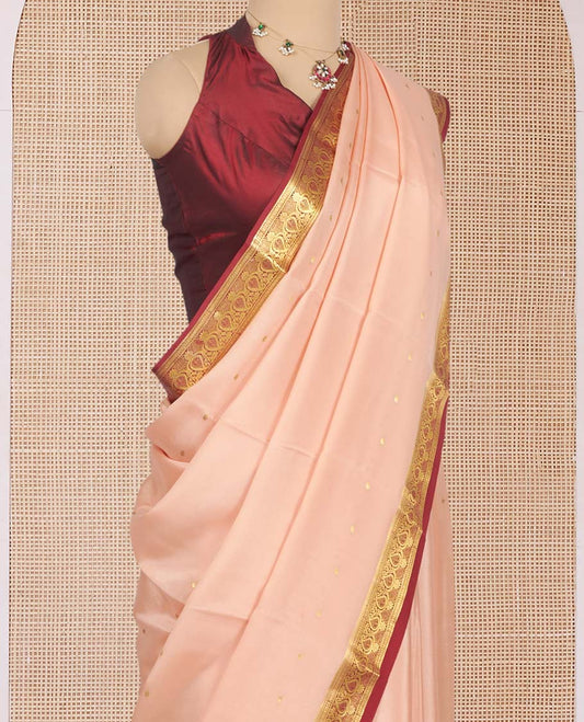 Light Peach Mysore Silk Saree, Mesmerized with Zari Buttas All Over Its Body, Complemented by a Contrast Traditional Zari Design Border, Zari-Buttas Woven Pallu, and Paired with a Contrast Blouse