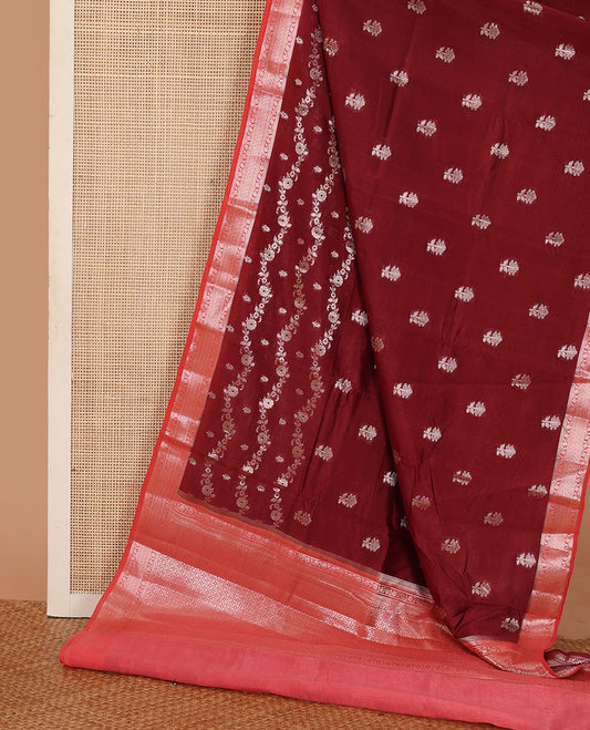 Maroon floral buttas, and floral creeper designs raw mango silk saree, contrast traditional zari border, and jaal pallu