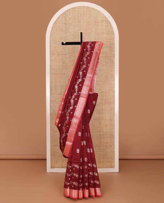Maroon floral buttas, and floral creeper designs raw mango silk saree, contrast traditional zari border, and jaal pallu