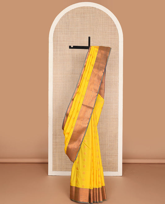 Yellow semi-soft silk saree with zari buttas, contrast traditional motifs zari border & pallu of jaal design