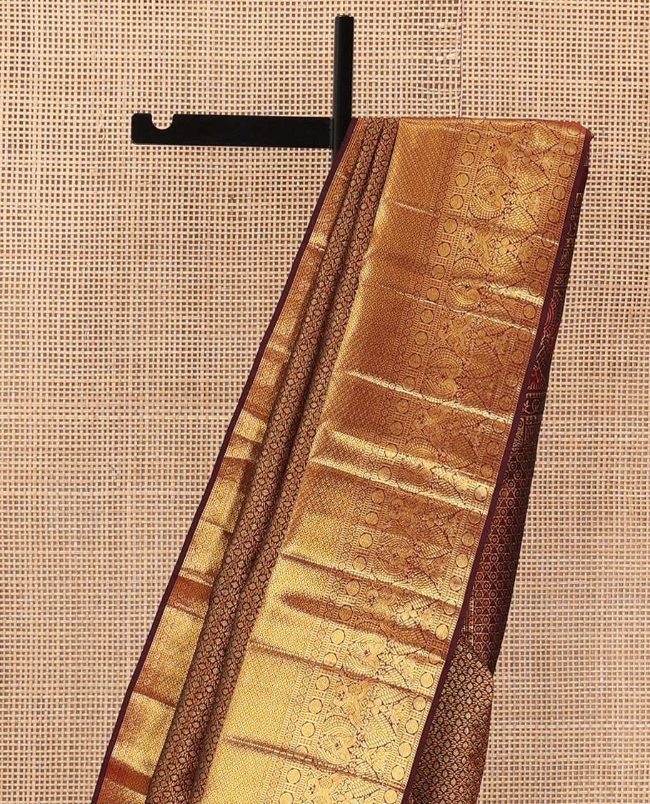 Maroon jacquard wedding silk saree, zari border of rekku, muthu, rudraksham, kamalam, then kuli kann, and mayil, and intricate pallu