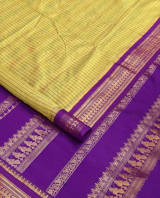Green checked nine-yard cotton saree, contrast temple traditional zari border of peacocks, and traditional design pallu