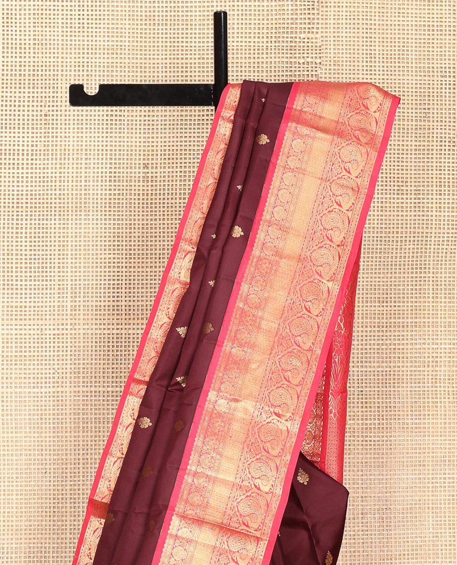 Brown Vasundhara Silk Saree, Decorated with Zari Buttas on Its Body, Complemented by a Contrast Traditional Zari Border of Mayil Designs, Grand Pallu Depicts Jaal and Floral Designs, and Paired with a Contrasting Blouse