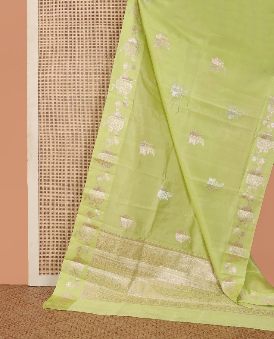 Green floral buttas raw mango silk saree, floral design border, and pallu adorned with floral, and geometric zari designs