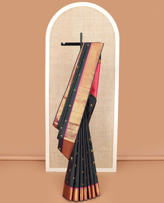 Black chakram buttas Kanchipuram silk saree, contrast border of thilakam mokku, banaras, muthu, poun, and zari stripes, and jaal pallu