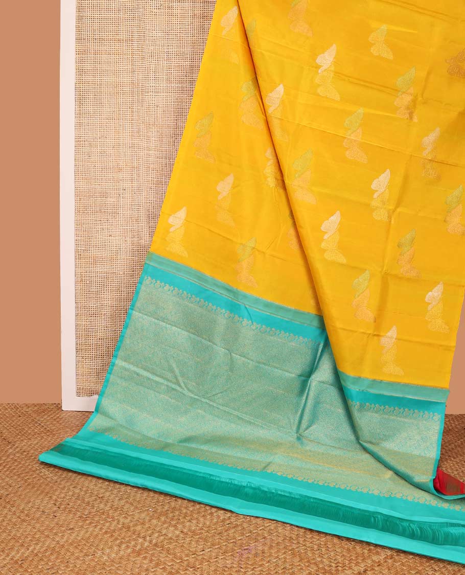 Borderless orange buttas kancheepuram silk saree with argyle design pallu