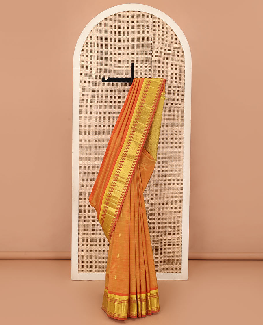 Orange zari buttas Kanchipuram silk saree, contrast one-sided border of panner sombu, muthu, banaras, and jaal, and floral creeper pallu