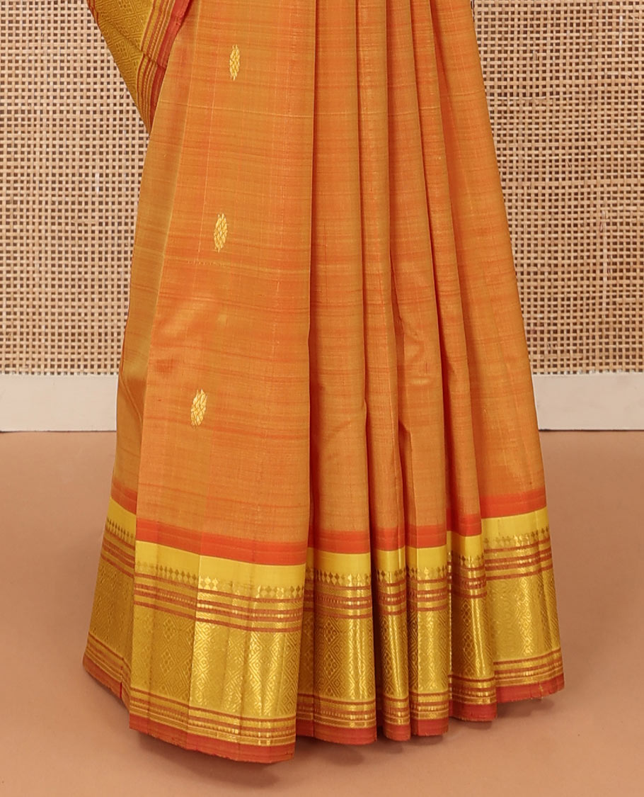 Orange zari buttas Kanchipuram silk saree, contrast one-sided border of panner sombu, muthu, banaras, and jaal, and floral creeper pallu