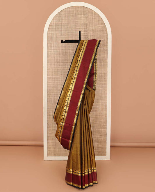 Mustard striped Kanchipuram silk saree, contrast rettai pettu border of manga and mayil kann designs, and zari striped pallu
