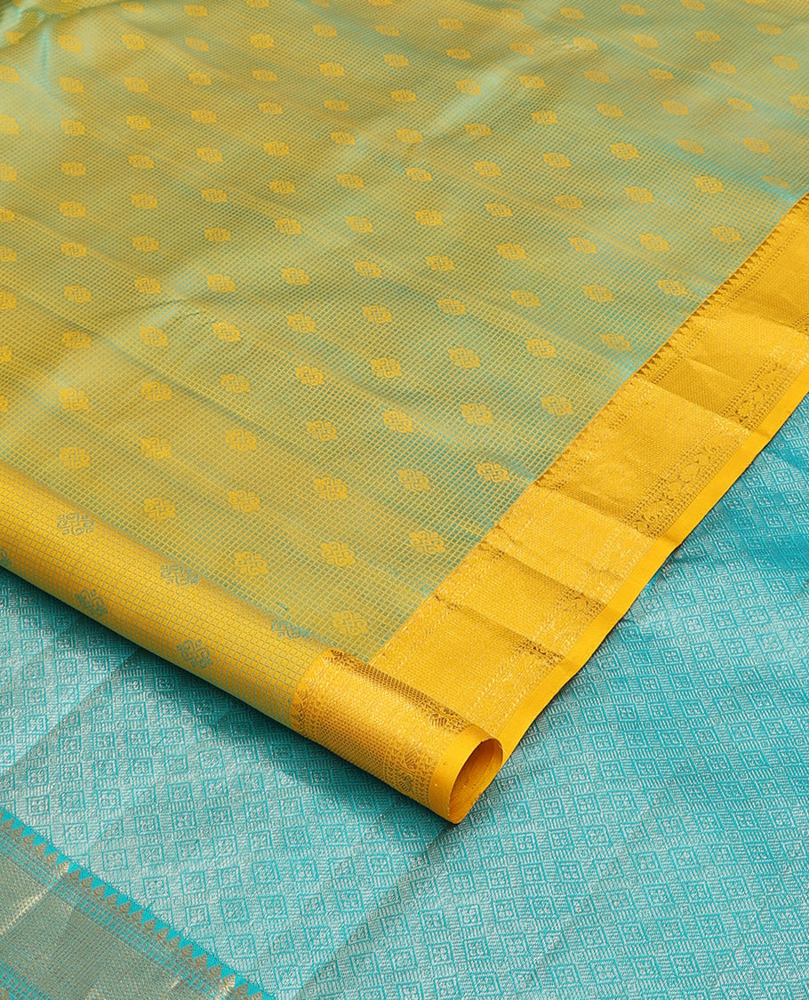 Yellow embossed silk saree, contrast border of thilakam mokku, muthu, ara bogudi, and kuyil kann, and jaal pallu
