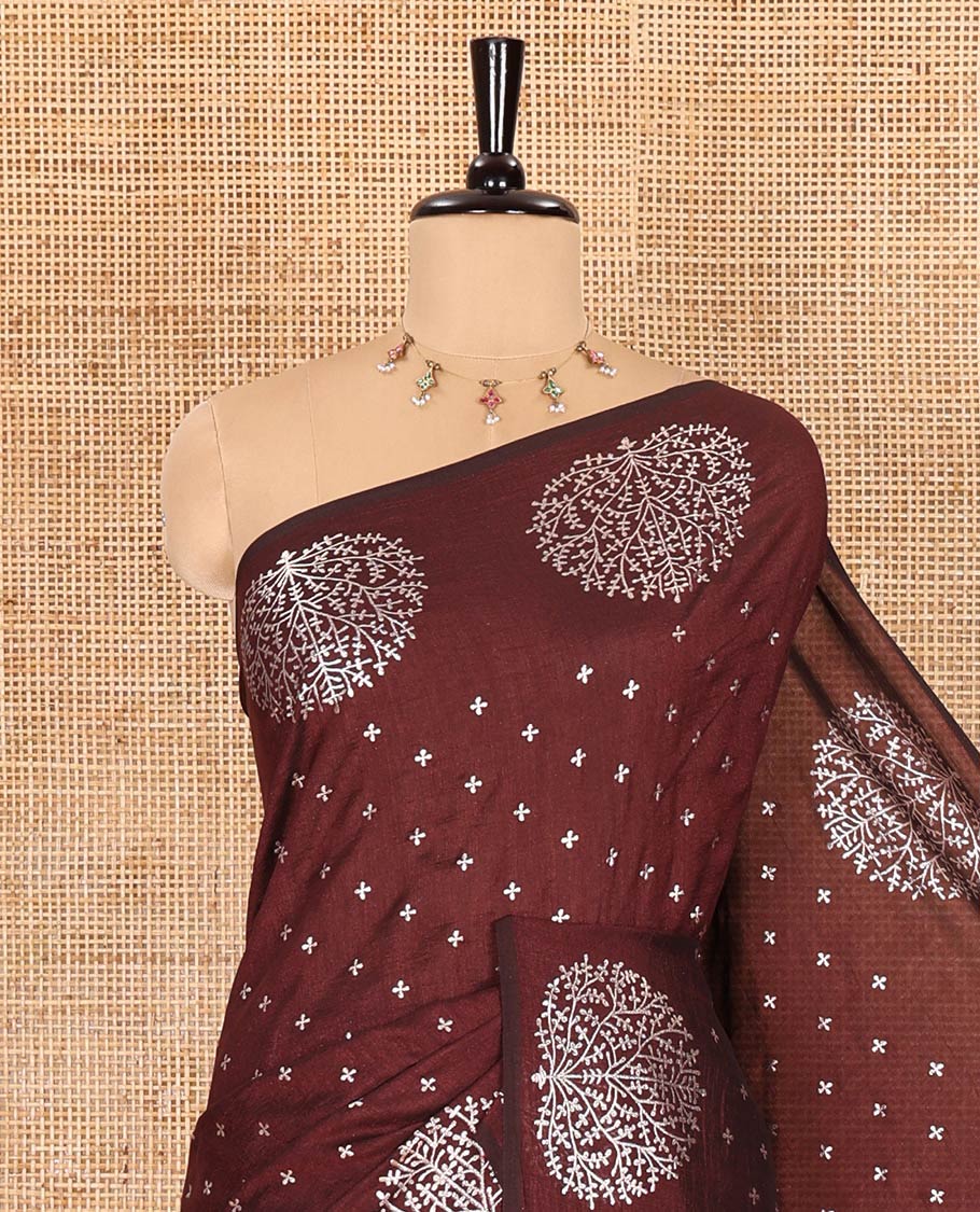Maroon plus buttas woven Vichitra silk saree, kalpavriksha tree motifs woven on its border, self-pallu, and no blouse