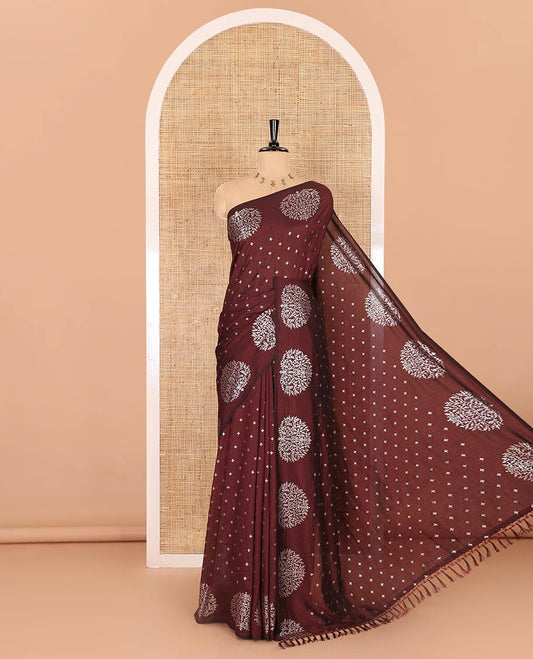 Maroon plus buttas woven Vichitra silk saree, kalpavriksha tree motifs woven on its border, self-pallu, and no blouse