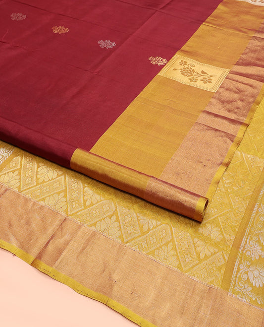 Maroon Uppada Silk Saree Detailed with Floral Zari Buttas, Complemented by a Contrast Border of Floral Butta Enclosed Square Design, Pallu Decked Up with Intricate Designs, and Paired with a Contrast Blouse