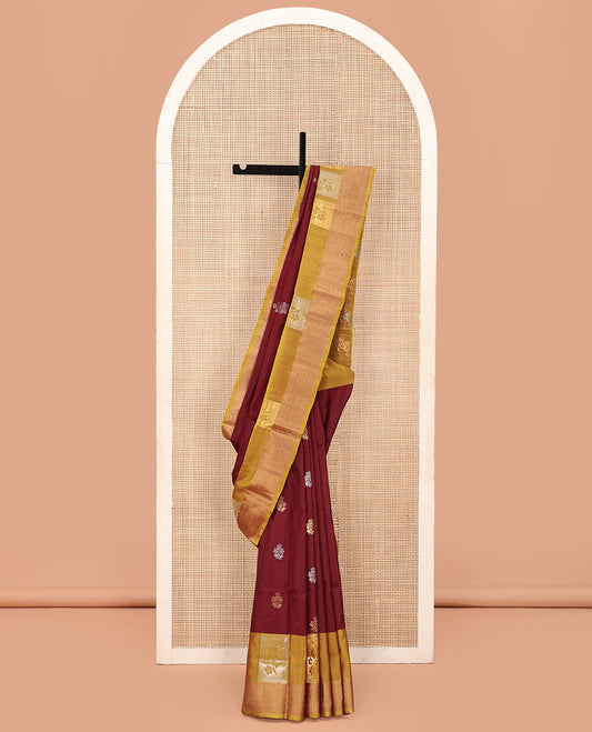 Maroon Uppada Silk Saree Detailed with Floral Zari Buttas, Complemented by a Contrast Border of Floral Butta Enclosed Square Design, Pallu Decked Up with Intricate Designs, and Paired with a Contrast Blouse