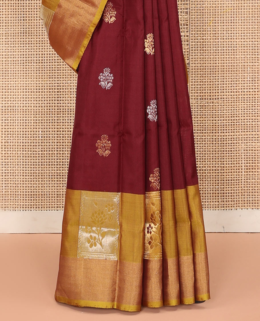 Maroon Uppada Silk Saree Detailed with Floral Zari Buttas, Complemented by a Contrast Border of Floral Butta Enclosed Square Design, Pallu Decked Up with Intricate Designs, and Paired with a Contrast Blouse