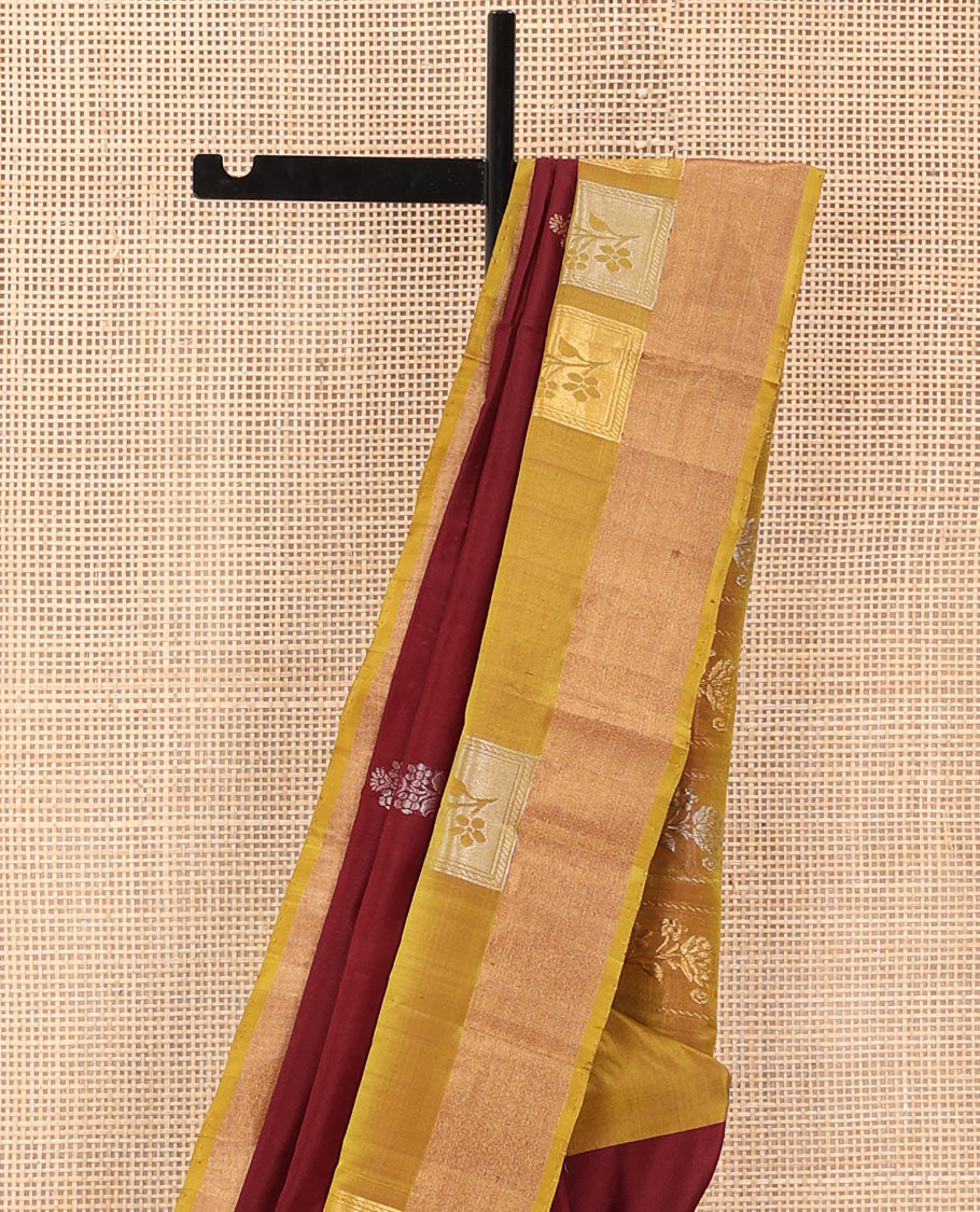 Maroon Uppada Silk Saree Detailed with Floral Zari Buttas, Complemented by a Contrast Border of Floral Butta Enclosed Square Design, Pallu Decked Up with Intricate Designs, and Paired with a Contrast Blouse