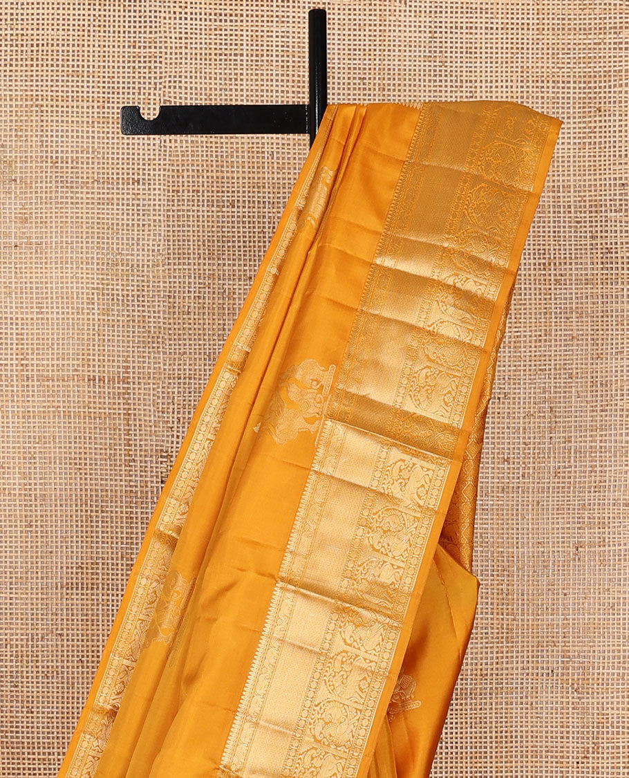 Yellow yaanai & singam buttas silksaree,zari border of thilakam,yaanai,mayil kann,rudraksham,muthu, mayil & yaali & butta enclosed checked pallu