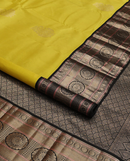 Yellow manga buttas silk saree, contrast border of muthu, diamond,poun, zari stripes & chakram designs & scallop design pallu