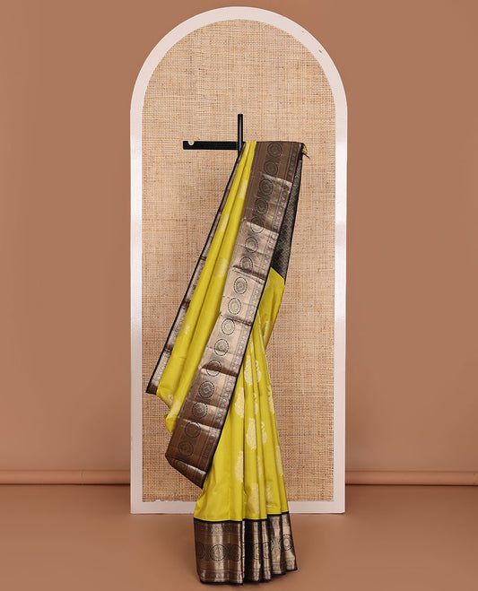 Yellow manga buttas silk saree, contrast border of muthu, diamond,poun, zari stripes & chakram designs & scallop design pallu