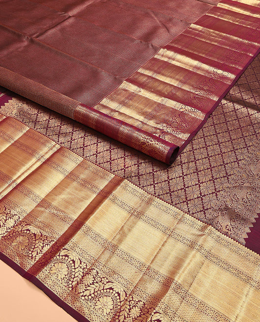 Maroon jacquard kanchipuram silk saree, zari border of traditional zari designs, and zari-rich pallu