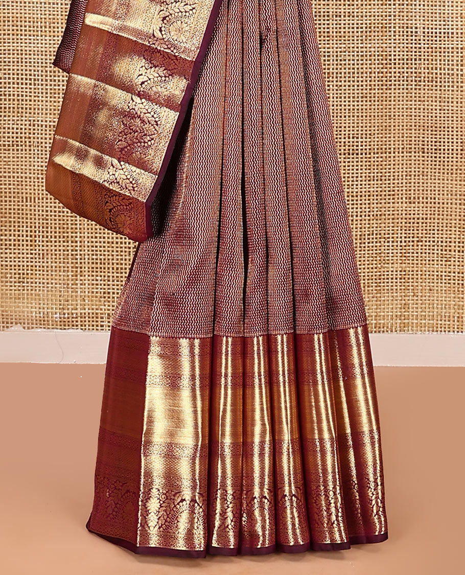 Maroon jacquard kanchipuram silk saree, zari border of traditional zari designs, and zari-rich pallu
