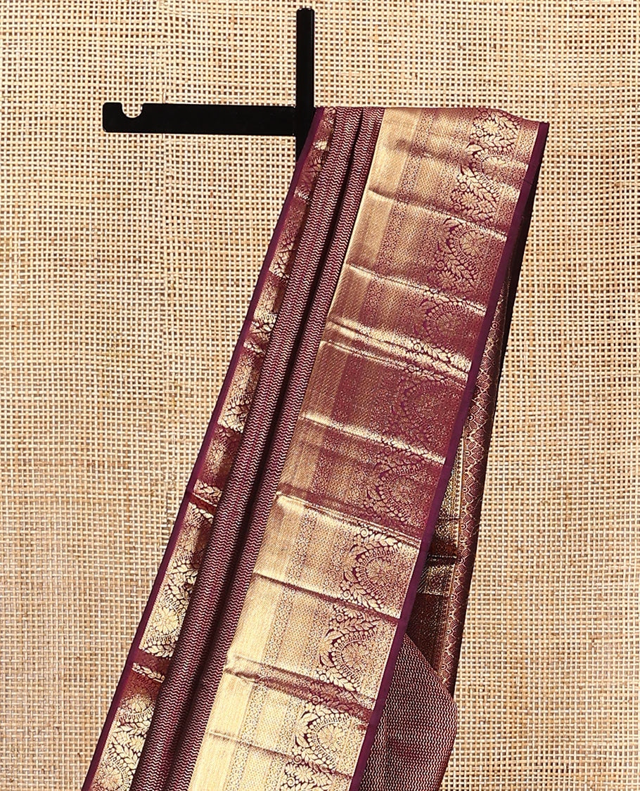 Maroon jacquard kanchipuram silk saree, zari border of traditional zari designs, and zari-rich pallu