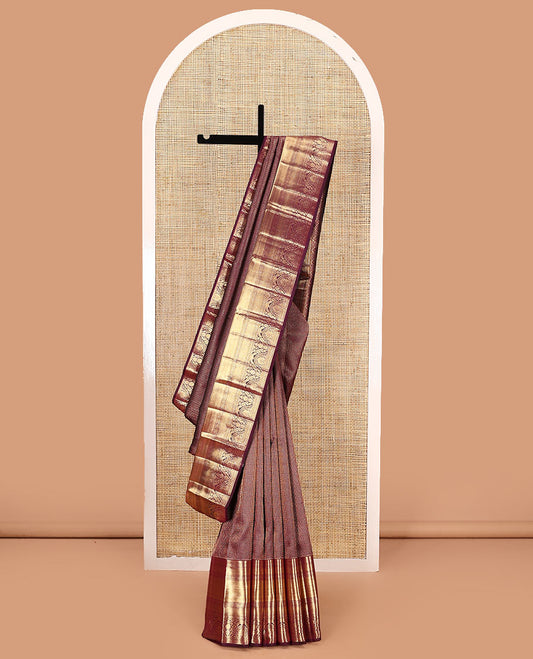 Maroon jacquard kanchipuram silk saree, zari border of traditional zari designs, and zari-rich pallu