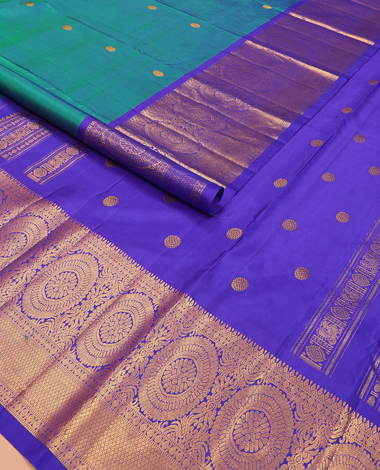 Blue chakram buttas Kanchipuram silk saree, contrast border of muthu, rudraksham,  poo chakram, and mayil kann designs, and chakram motifs pallu