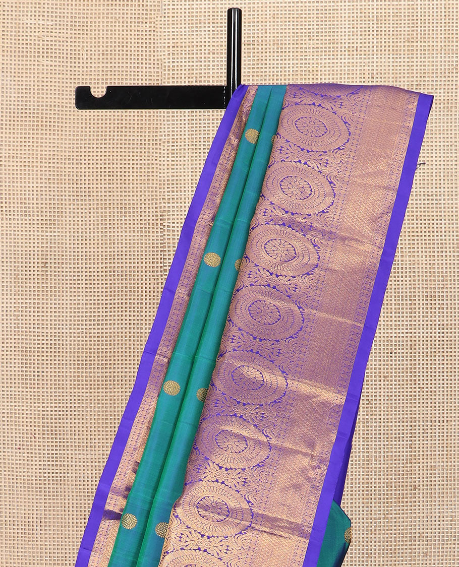 Blue chakram buttas Kanchipuram silk saree, contrast border of muthu, rudraksham,  poo chakram, and mayil kann designs, and chakram motifs pallu