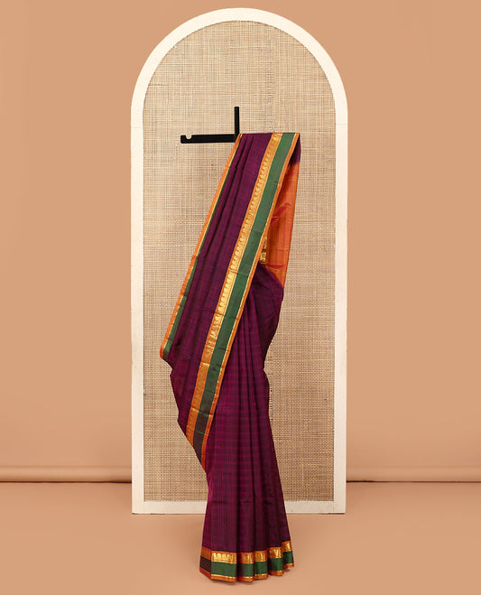 Purple Kanchipuram silk saree, contrast rettai pettu border of manga, neli, and diamond designs, and zari striped pallu