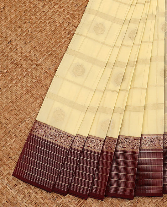 Cream butta enclosed checked budget silk saree, contrast traditional zari design border, and jaal pallu