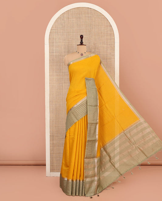 Yellow Plain Assam Silk Saree, Complemented by Captivating Contrast Border Featuring Traditional Zari Designs, Gleaming Zari Woven Pallu, and Paired with a Contrast Blouse