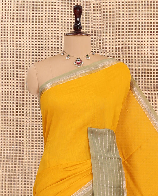 Yellow Plain Assam Silk Saree, Complemented by Captivating Contrast Border Featuring Traditional Zari Designs, Gleaming Zari Woven Pallu, and Paired with a Contrast Blouse