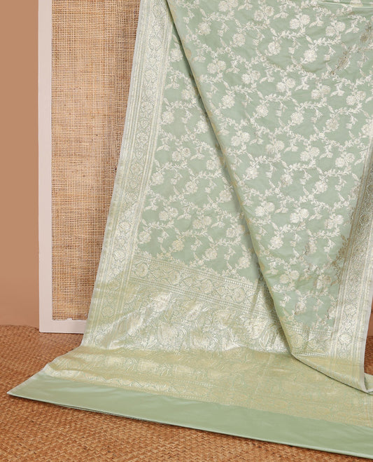 Pistachio green floral jacquard semi banaras satin, self-border & pallu steeped with intricate designs