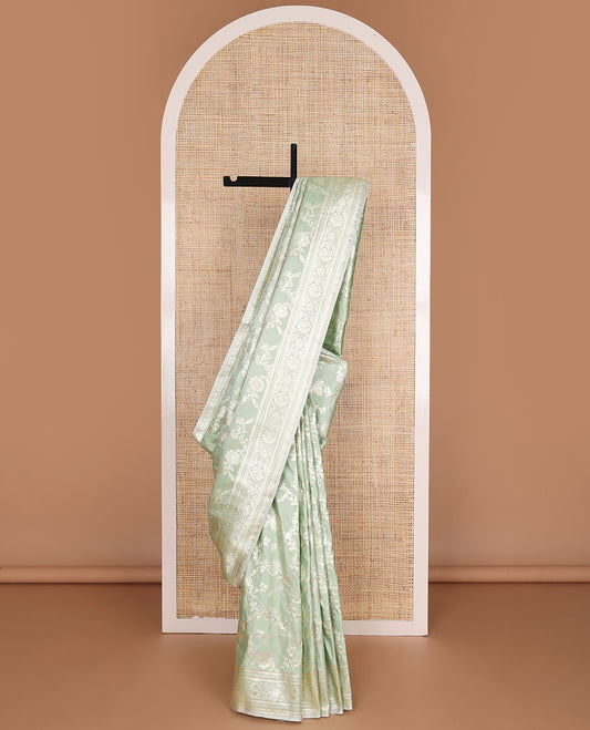 Pistachio green floral jacquard semi banaras satin, self-border & pallu steeped with intricate designs