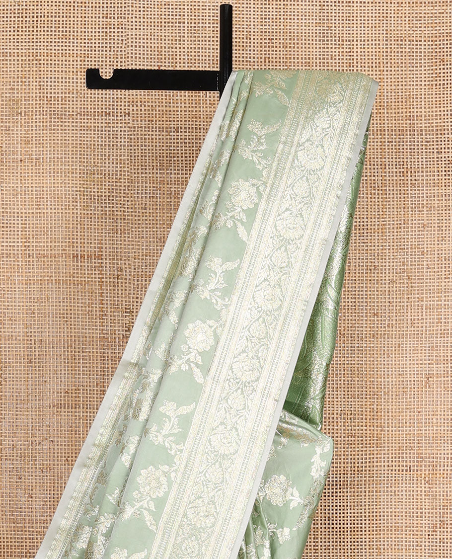 Pistachio green floral jacquard semi banaras satin, self-border & pallu steeped with intricate designs
