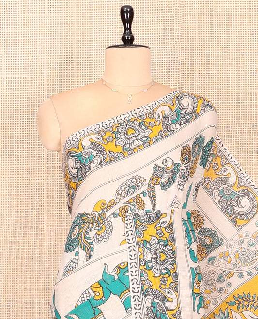 Off-White Kalamkari Cotton Saree Features Flora, Fauna, Human Motifs Print, Contrast Kalamkari Printed Border, Peacock Pallu, and a Matching Blouse