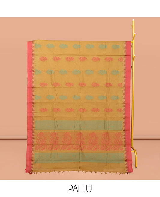 Mustard Kanchi Cotton Saree, Ornamented with Buttas All Over Its Body, Complemented by a Contrast Temple Border, Pallu of Floral Design, and Paired with a Matching Blouse