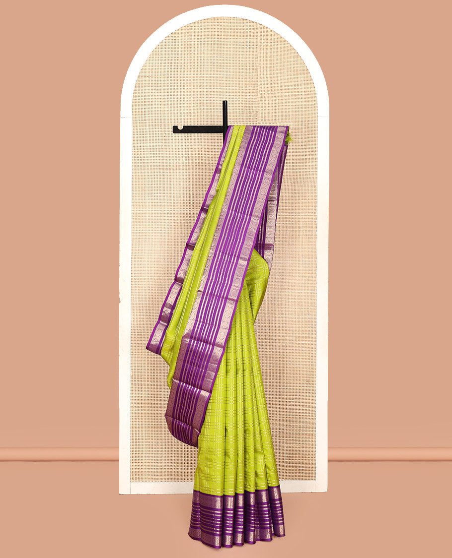 Green Vasundhara Silk Saree, Spotlighted with Zari Checked Design All Over Its Body, Complemented by a Contrast Varisai Pettu Border of Muthu, Poun, and Chakram Designs, Grandly Embellished Pallu of Jaal Designs, and Paired with a Contrast Blouse