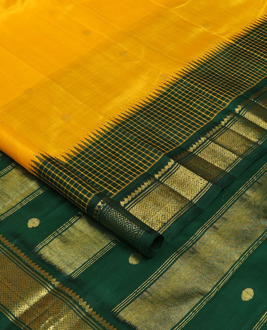 Yellow zari buttas Kanchipuram silk saree, contrast one-sided thazampoo rekku micro-checked border of salangai,banaras & jaal & zari design pallu