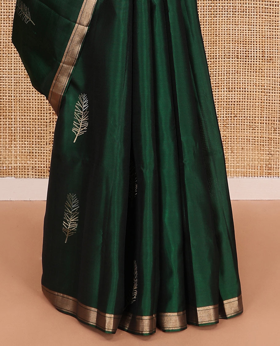 Green leaf buttas soft silk saree, piping zari border, and pallu steeped with unique leaf motifs