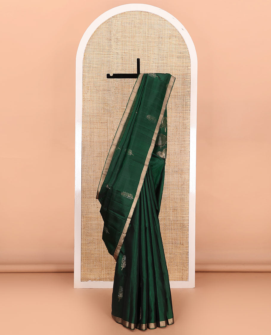 Green leaf buttas soft silk saree, piping zari border, and pallu steeped with unique leaf motifs