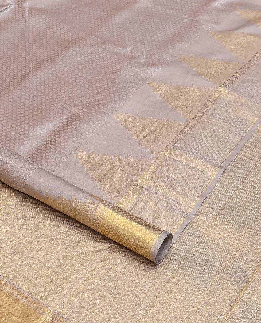 Grey embossed silk saree, thazampoo rekku golden zari border of thilakam mokku, muthu, and vanki designs, and zari rich jaal pallu