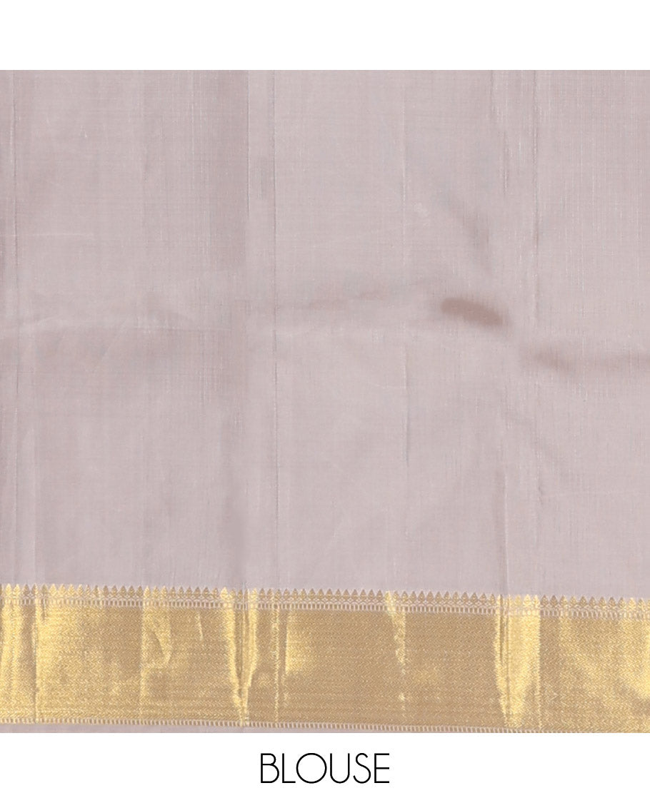 Grey embossed silk saree, thazampoo rekku golden zari border of thilakam mokku, muthu, and vanki designs, and zari rich jaal pallu