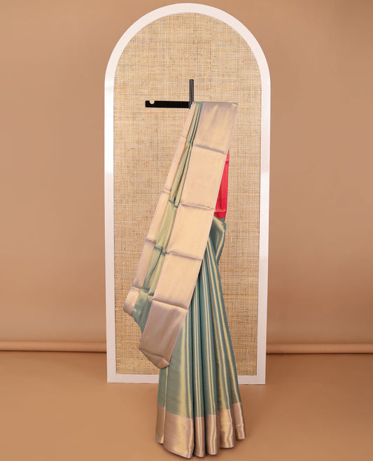 Dark green chevron design semi tissue saree with contrast zari design border & striped pallu