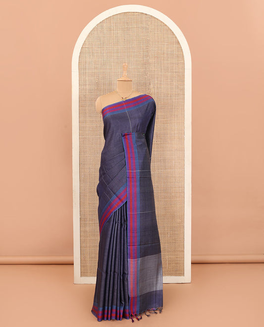 Navy blue vertically striped tussar silk saree with contrast thread woven border, and plain pallu
