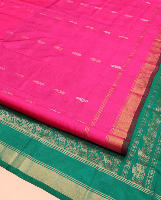 Rani Pink Uppada Silk Saree Elegantly Highlighted with Zari Buttas, Subtle Zari Border, Complemented by a Pallu of Peacock and Paisley Designs, and Paired with a Contrast Blouse