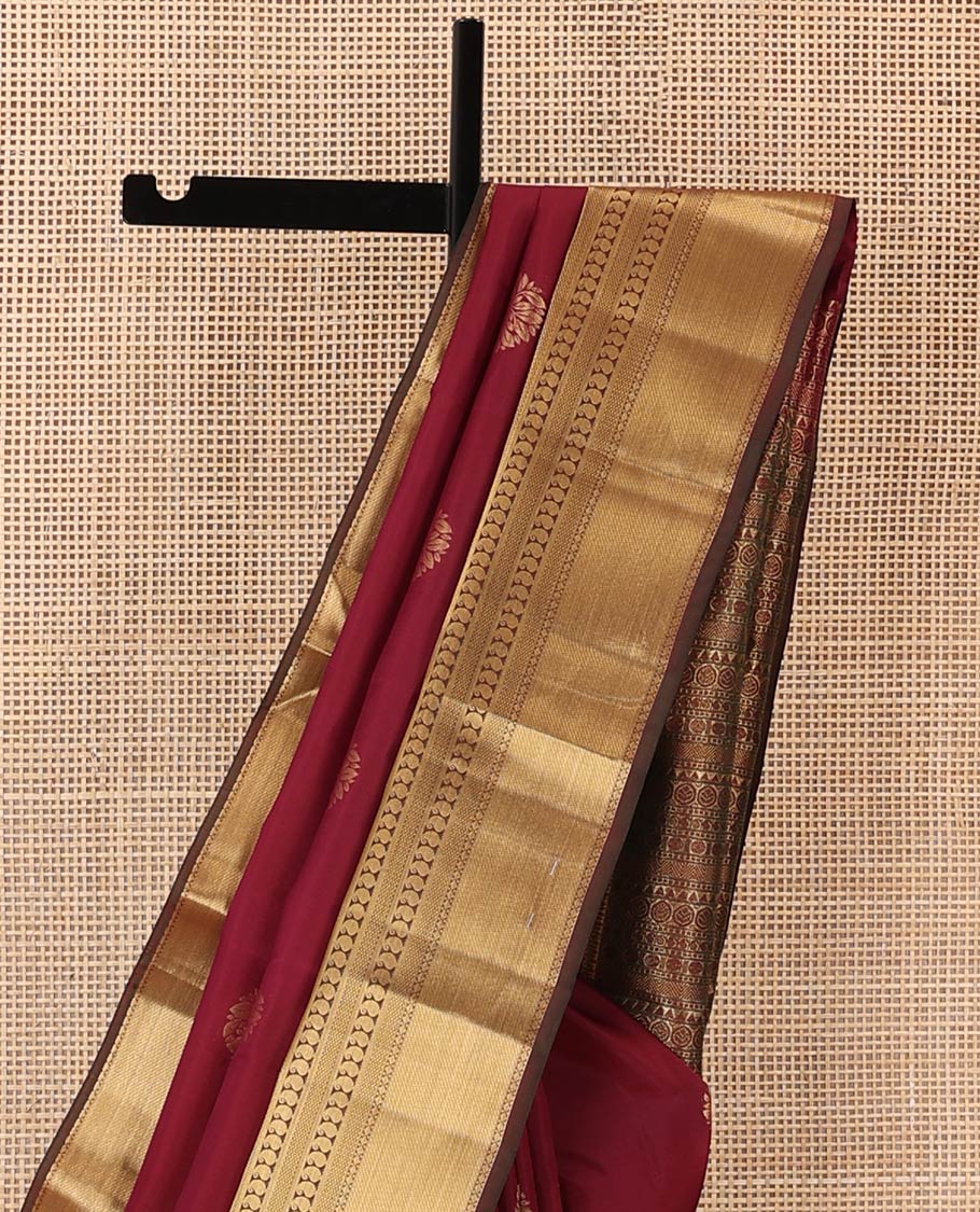 Maroon zari buttas Vasundhara silk mix saree, contrast border of thilakam, mayil kann, diamond, and manga designs, and geometric patterned pallu