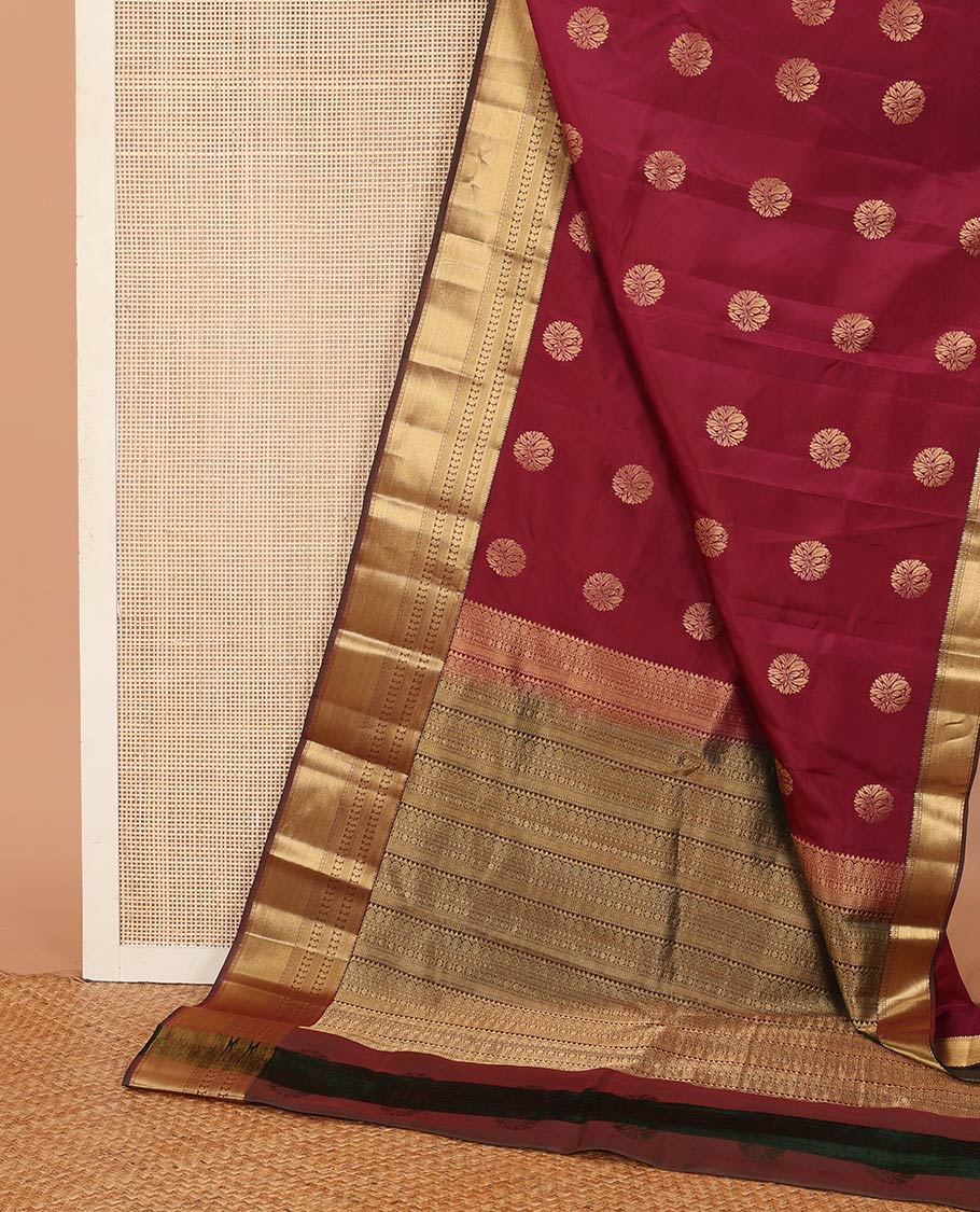 Maroon zari buttas Vasundhara silk mix saree, contrast border of thilakam, mayil kann, diamond, and manga designs, and geometric patterned pallu